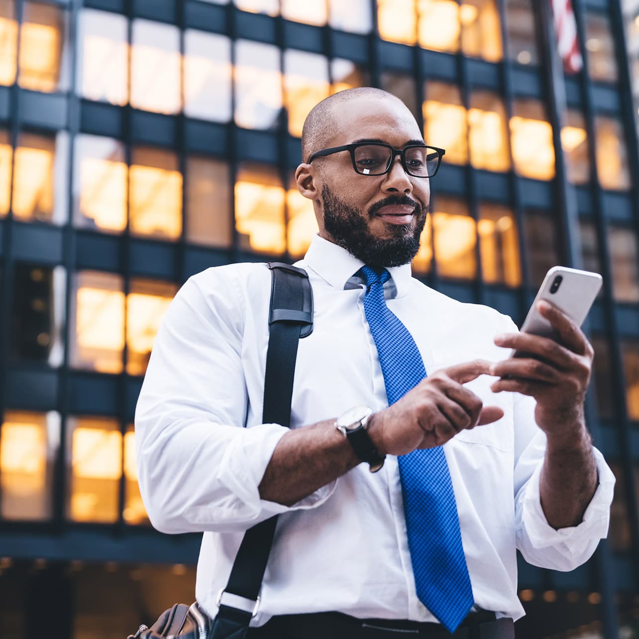 Business professional using a tablet, showcasing features like bank connections, format libraries, and end-to-end connectivity.
